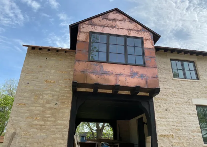 Copper metal panel facade on a stone building for Skylight Installation in Bulverde